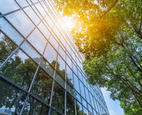 Image of a commercial building with greenery in front