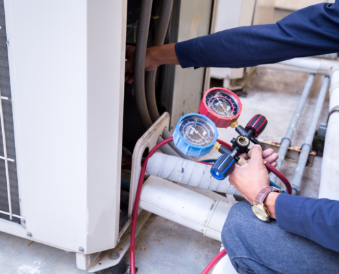 Technician is checking air conditioner ,measuring equipment for filling air conditioners.