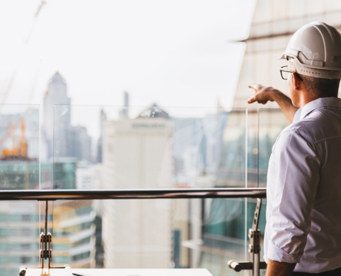 Portrait engineer man wearing safety helmet standing back