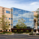 An office building with glass windows on a sunny day
