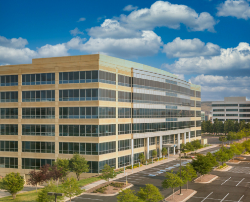 A Modern White Concrete And Blue Glass Office Building
