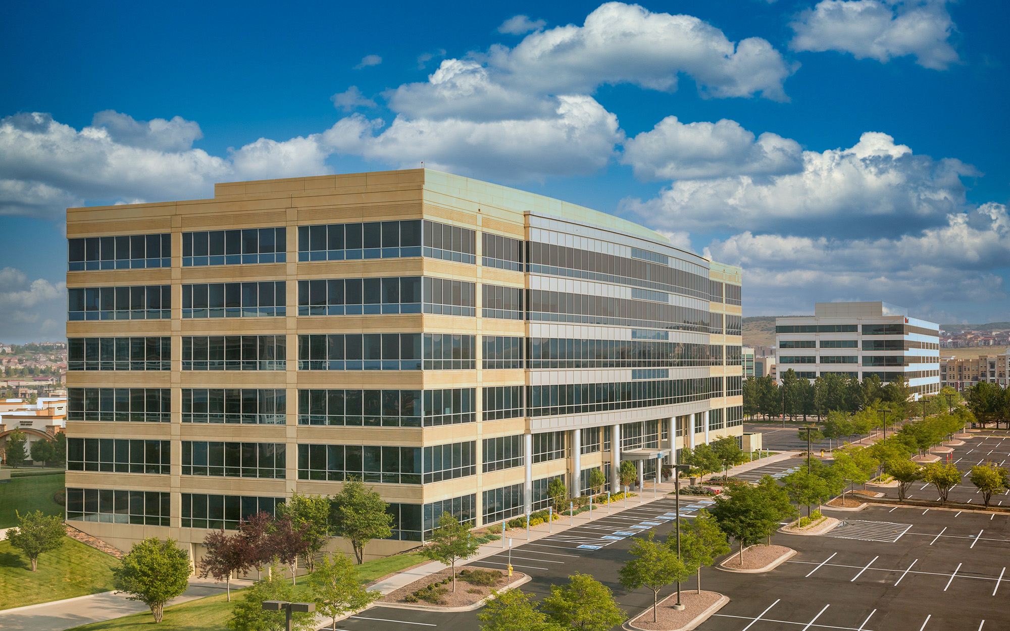 A Modern White Concrete And Blue Glass Office Building