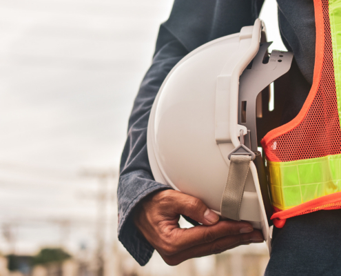 Engineer Holding White Helmet Safety Hard Hat